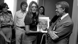 Gloria Steinem, editor of "MS" magazine presents democratic presidential nominee Jimmy Carter a copy of the magazine which features his mother, "Miss Lillian" on the cover. Carter visited his headquarters in Atlanta, August 30, 1976. (AP Photo)